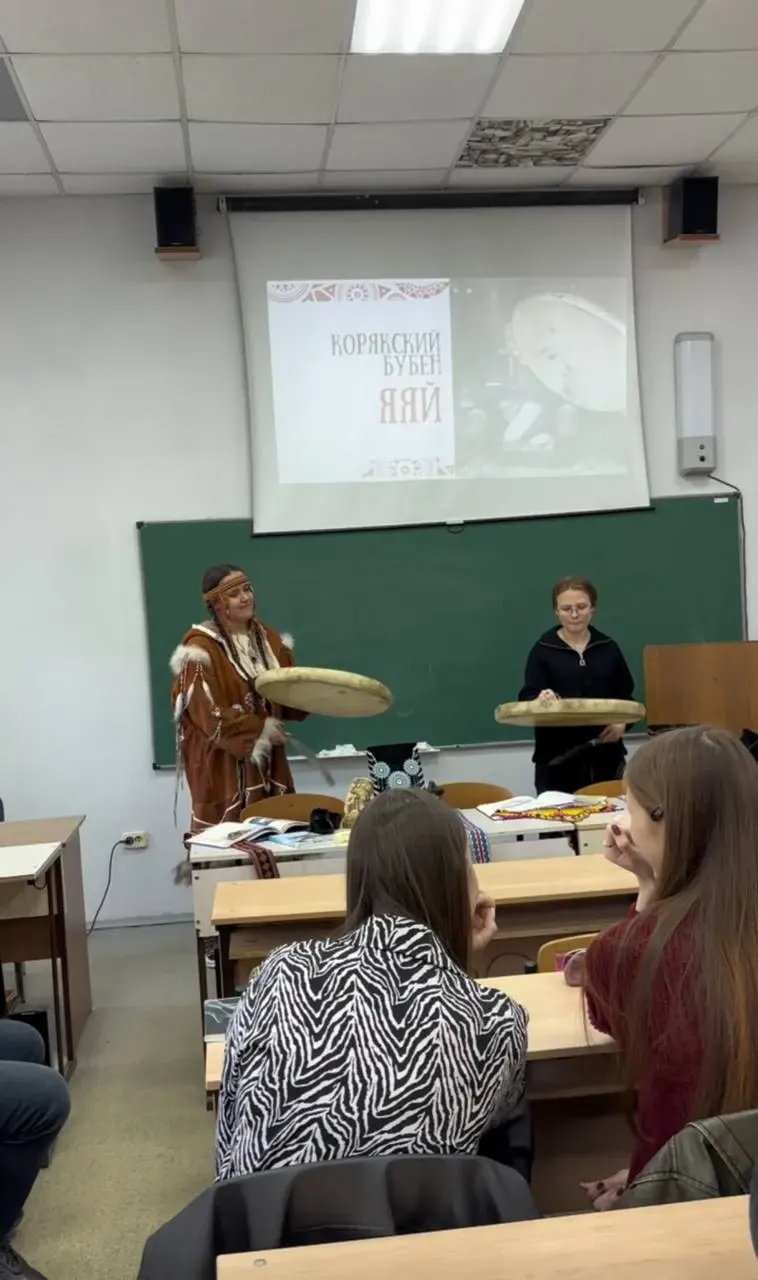 Две участницы демонстрируют игру на бубнах перед аудиторией